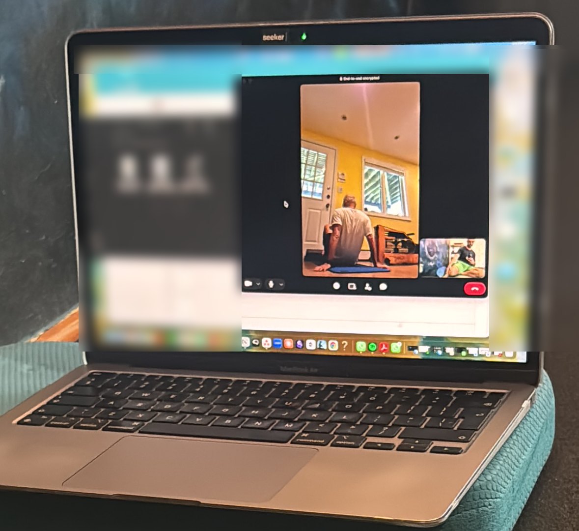 An online session on a laptop: the client follows his program at home while Alexandru coaches him on a video call